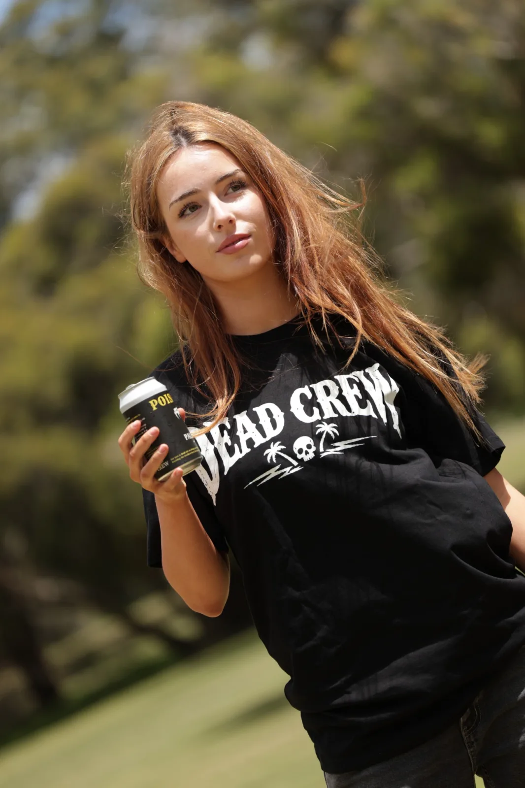 Model in branded streetwear outdoors with a canned drink