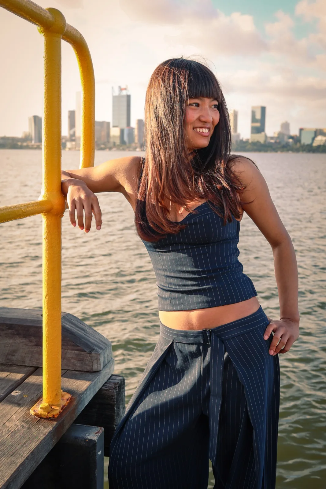 Fashion portrait beside the water with the Perth skyline behind